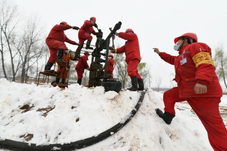 中原油田天然气产销厂文23储气库项目部值班人员在大雪中坚持场站设备